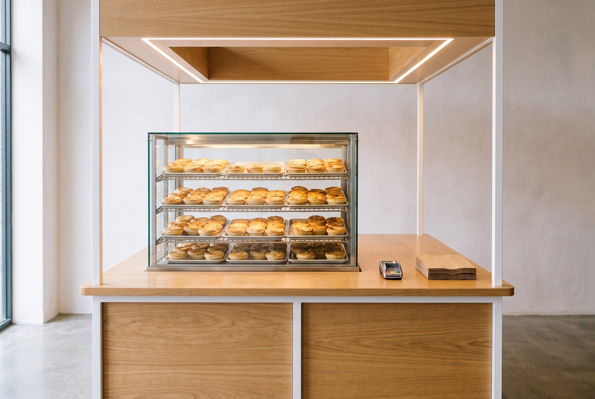 Illustration of a pie kiosk with a glass warmer in a mall basement. It is not a photograph of our kiosk.